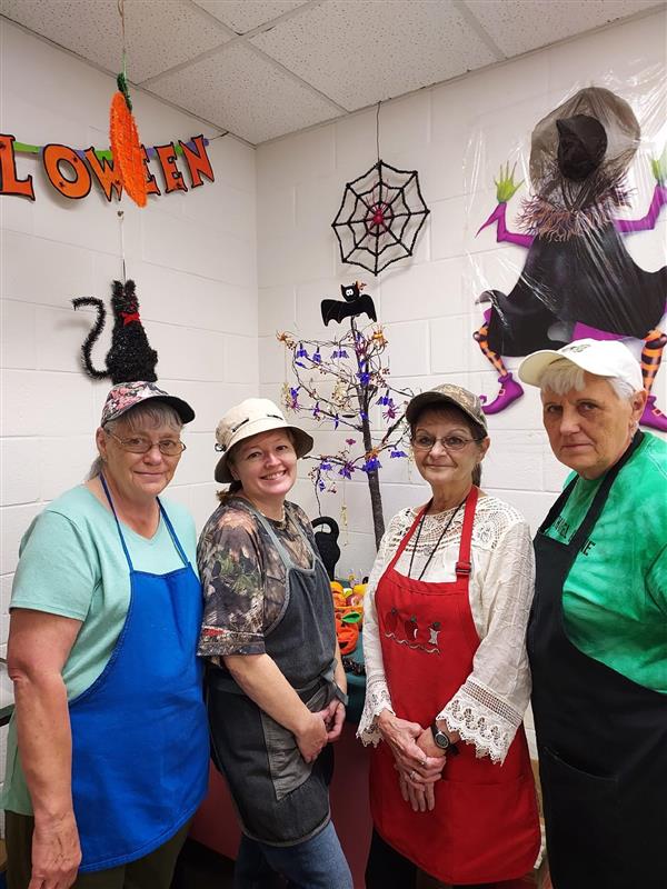 NGES Staff posing with Halloween Decorations